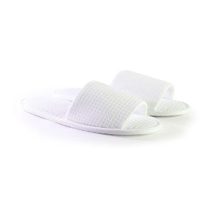 White spa slippers with textured fabric upper and cushioned sole – comfortable hotel & salon footwear